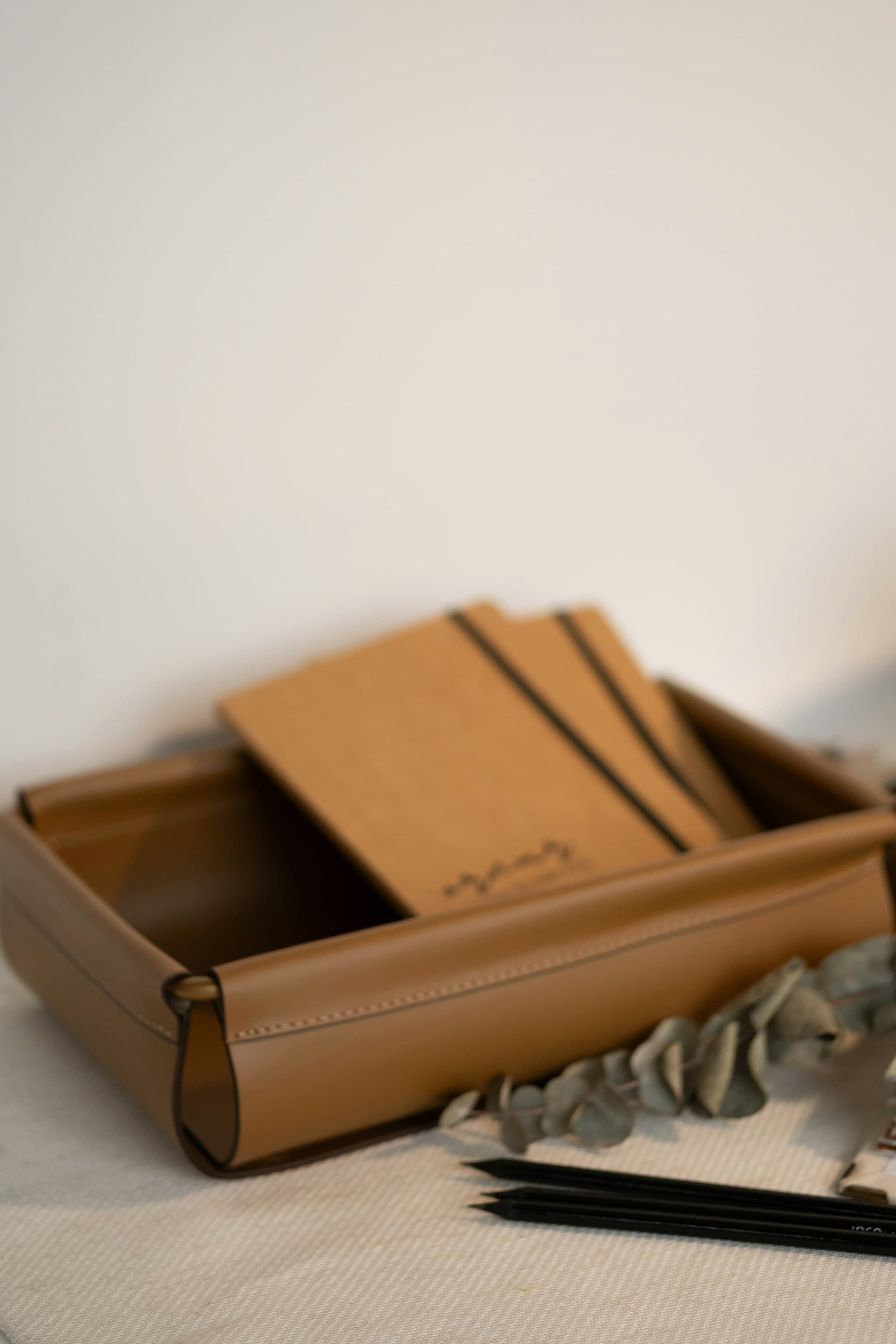 Custom notebooks in a leather tray